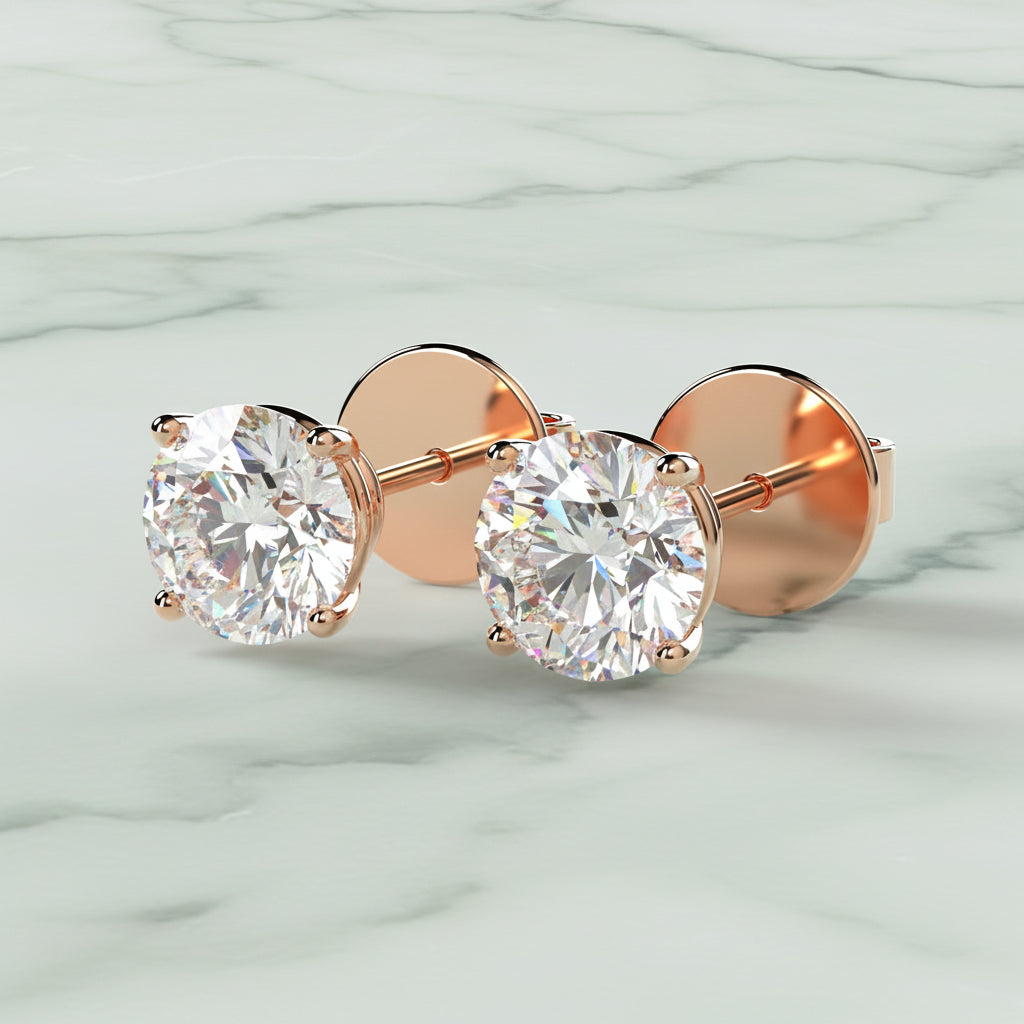Rose gold stud earrings with clear gemstones on a light beige background