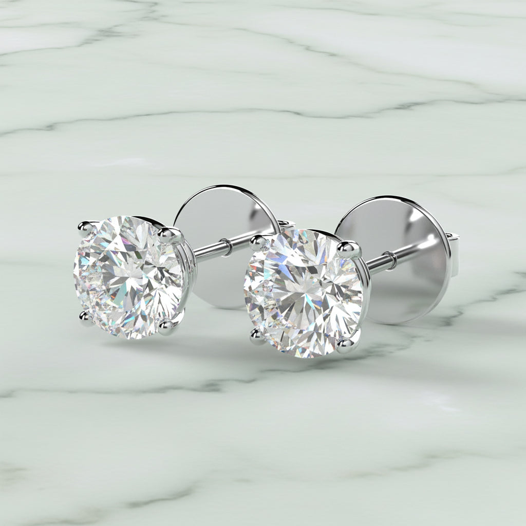 Pair of diamond stud earrings on a light beige background