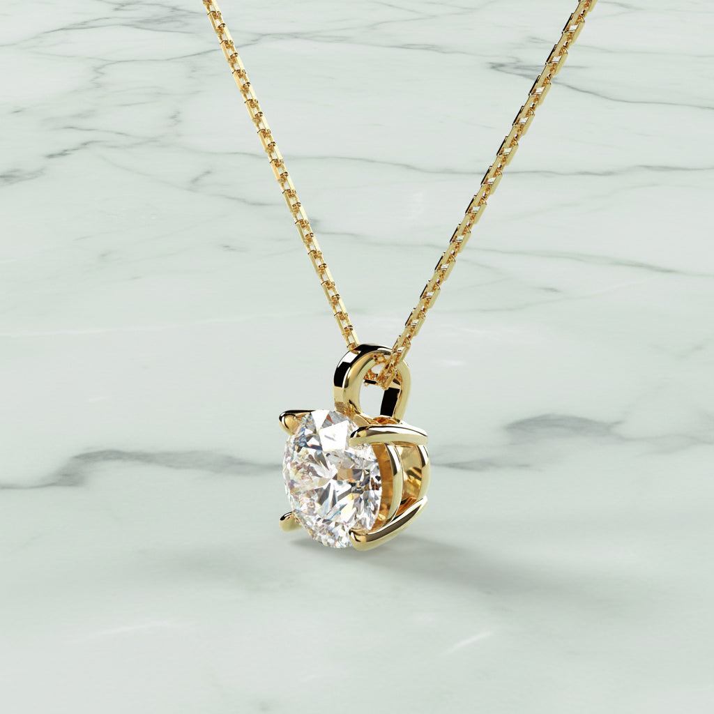 Gold necklace with a heart-shaped diamond pendant on a beige background