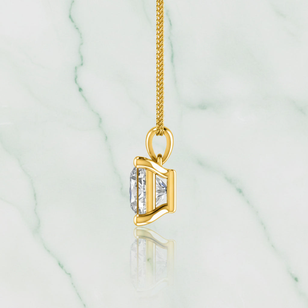 Gold necklace with a diamond pendant on a white background