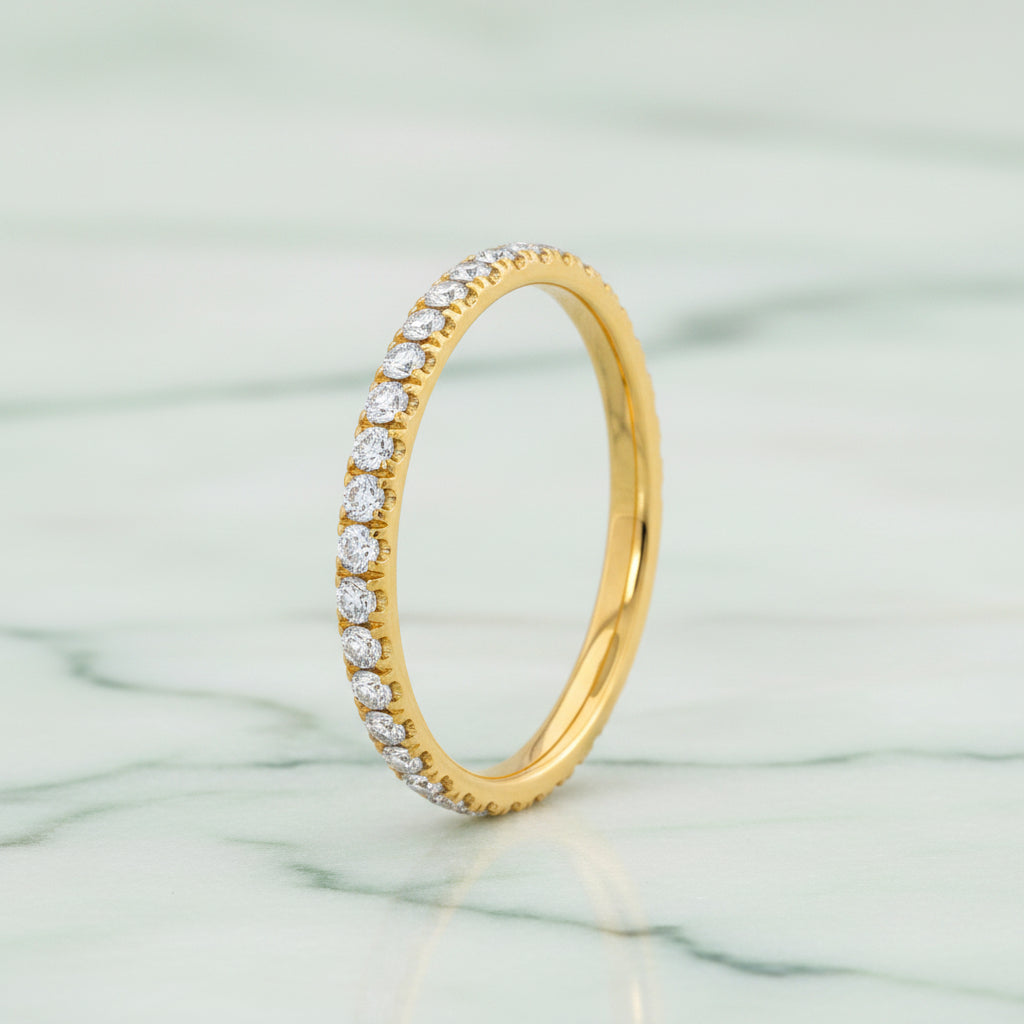 Gold ring with diamonds on a white background